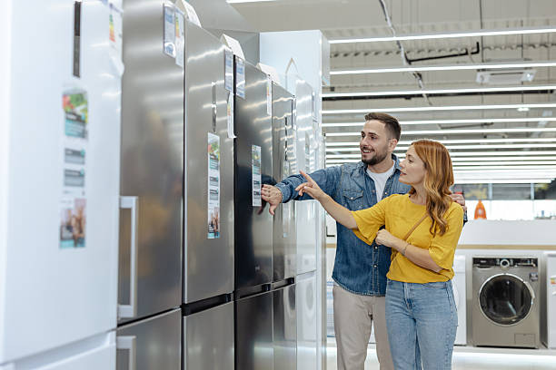 Shoppers exploring appliances in a retail showroom